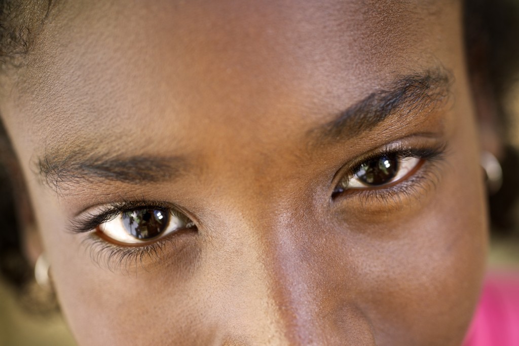 Portrait of happy young african girl looking at camera, smiling