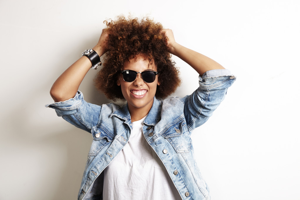 pretty african woman have fun with her curly hair